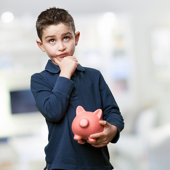 little kid thinking with piggy bank